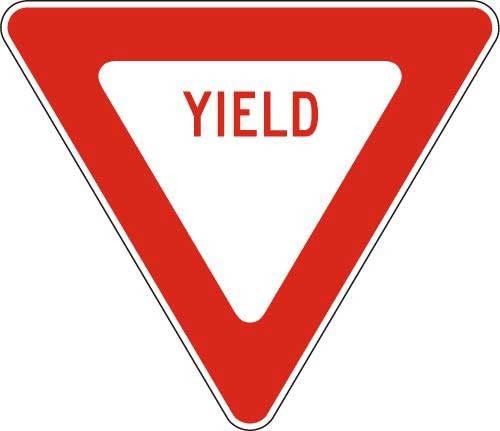 A white triangle sign with a very thick red border inside and Yield in red letters